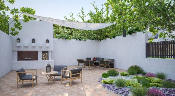 Cozy outdoor seating area with modern furniture and greenery under a light canopy.