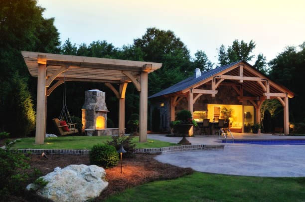Cozy outdoor seating area with warm lighting and fire pit at dusk.