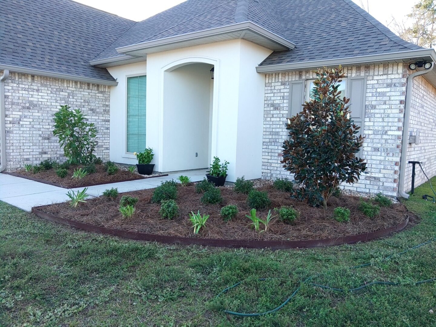 Neatly landscaped front yard with fresh mulch and shrubs.